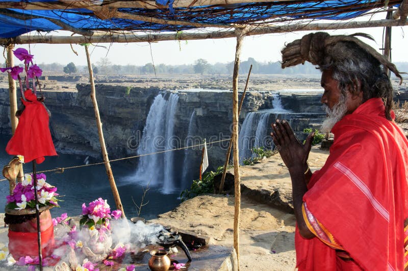 A Hindu monk is busy in his daily ritual in the morning in front of Chitrakote waterfall in Chhattisgarh.