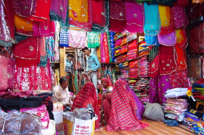 Hindu women dressed in colorful sari in Indian street market