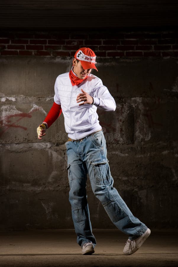 Hip Hop Boy Dancing in Modern Style Over Grey Wall Stock Photo Image