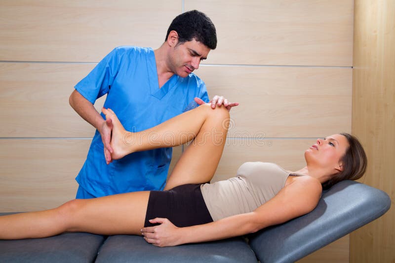 Hip mobilization therapy by physiotherapist to woman patient stock image Hip mobilization therapy by physiotherapist to woman patient stock image