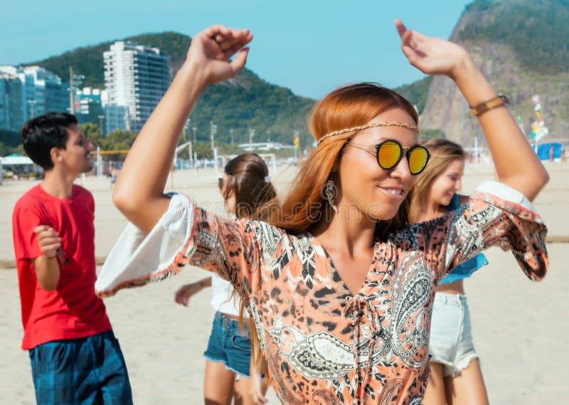 Hippy girl with group of man and woman at open air festival