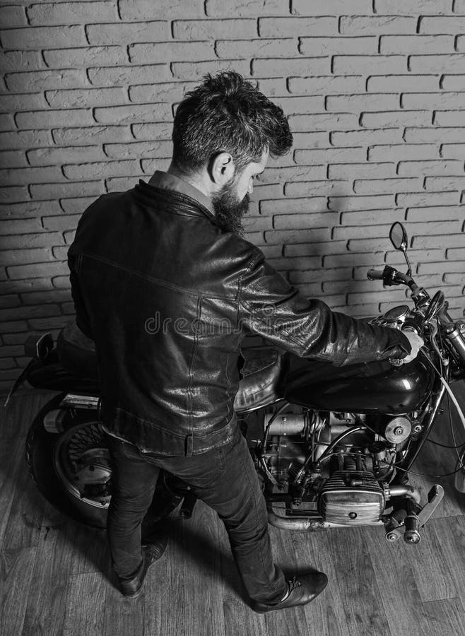 Hipster, Brutal Biker In Leather Jacket Sits Down On Motorcycle, Rear ...