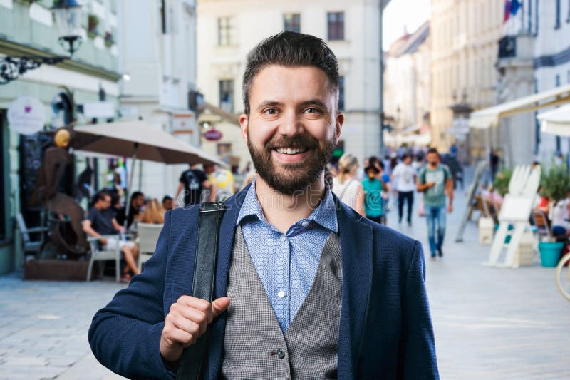 Hipster businessman in blue shirt in the city