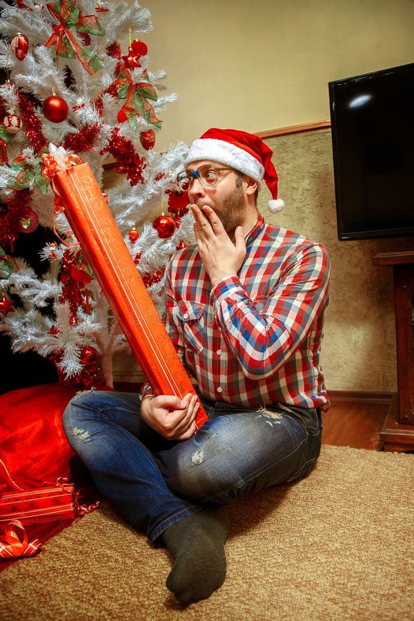 Hipster gets a long Christmas present stock images