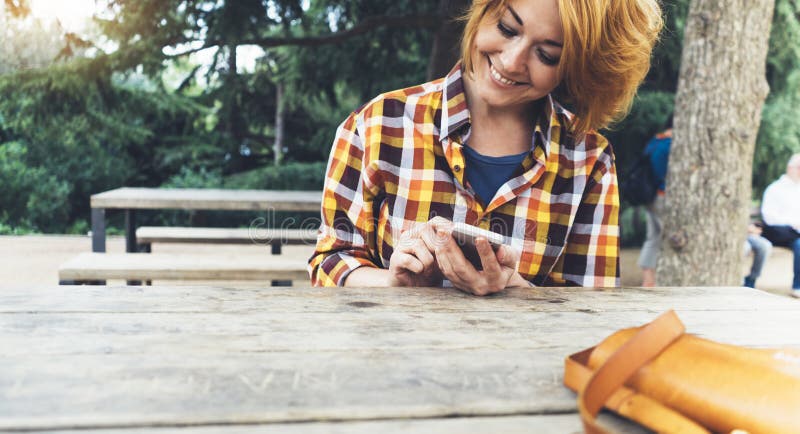 Hipster girl using phone technology internet, blogger person holding mobile smartphone on background sun city, female hands text stock photo Hipster girl using phone technology internet, blogger person holding mobile smartphone on background sun city, female hands text stock photo