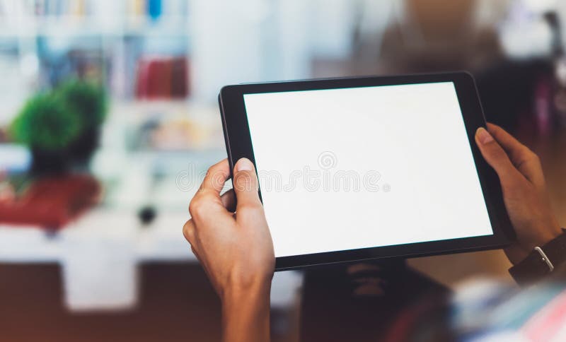 Hipster girl using tablet technology in home atmosphere, girl person holding computer with blank screen on background bokeh, femal
