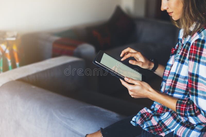 Hipster girl using tablet technology in home atmosphere, girl person holding computer with blank screen on background bokeh royalty free stock image Hipster girl using tablet technology in home atmosphere, girl person holding computer with blank screen on background bokeh royalty free stock image