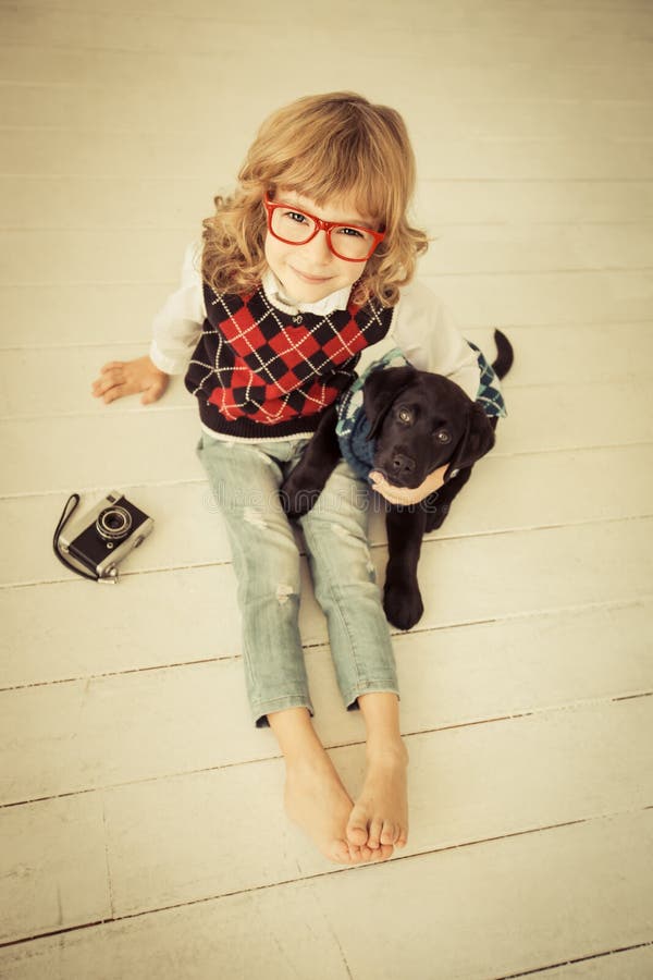 Hipster kid and dog. Child playing at home