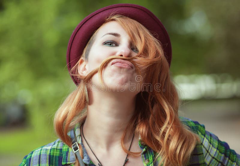 Hipster Redhead Woman Making A Moustache With Her Hair Stock Image