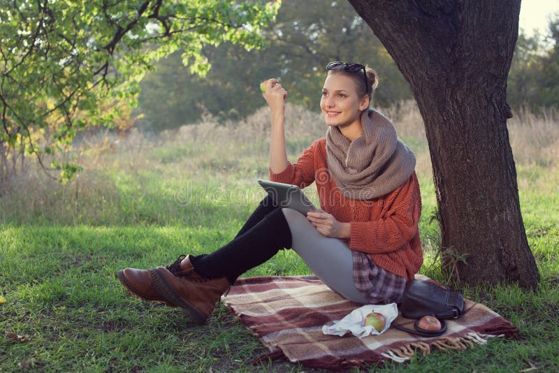 Hipster style young woman using tablet pc royalty free stock image