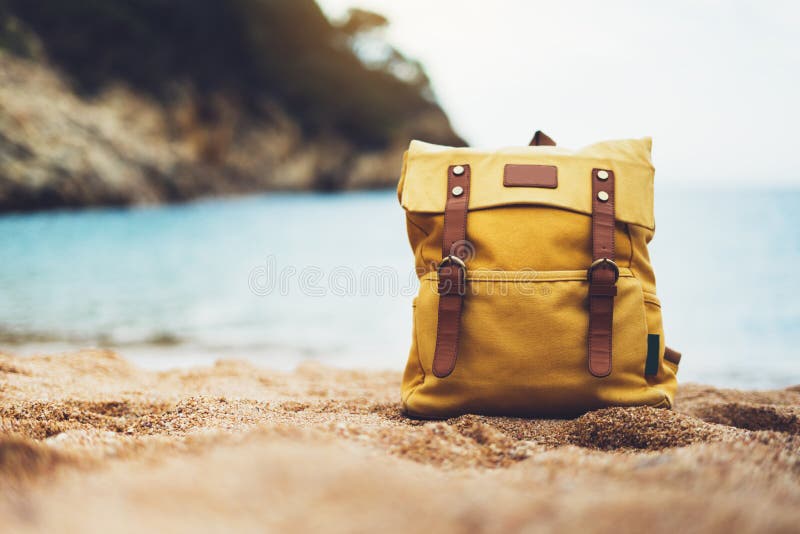 Hipster swimming mask on background blue sea ocean horizon, hiker tourist yellow backpack on sand beach, blurred panoramic sea