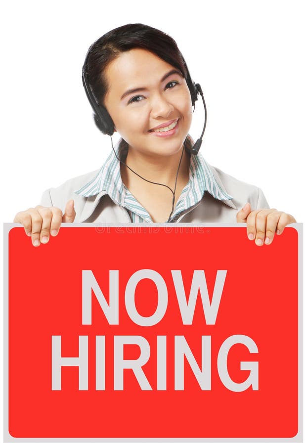 A woman wearing a headset holding a sign on hiring. A woman wearing a headset holding a sign on hiring