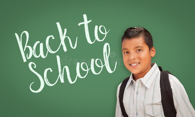 Hispanic Boy In Front of Back To School Chalk Board.