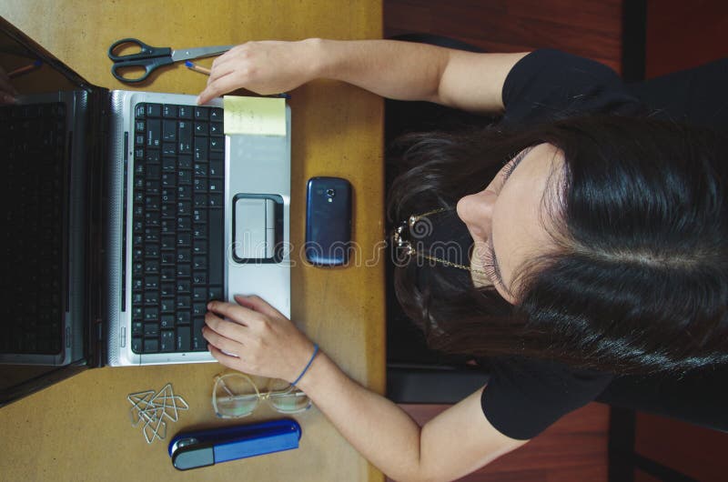 Hispanic brunette office woman working on laptop royalty free stock images Hispanic brunette office woman working on laptop royalty free stock images