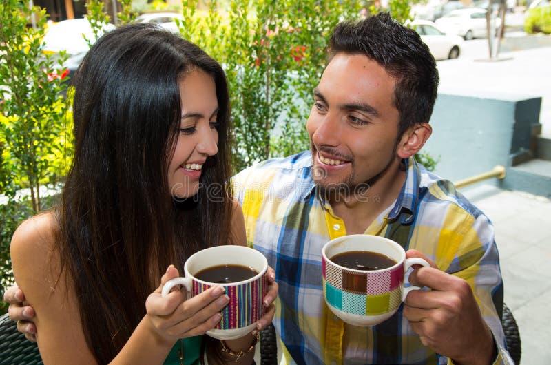 Hispanic cute couple enjoying coffee during a cozy stock photo