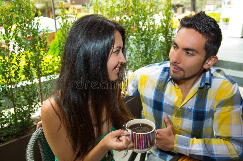 Hispanic cute couple enjoying coffee during a cozy stock images