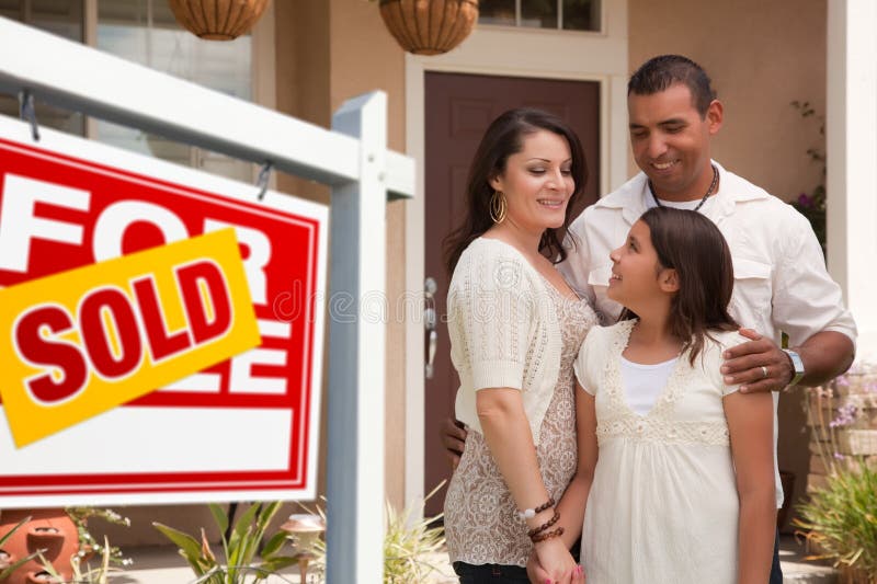 Hispanic Family in Front of Their New Home