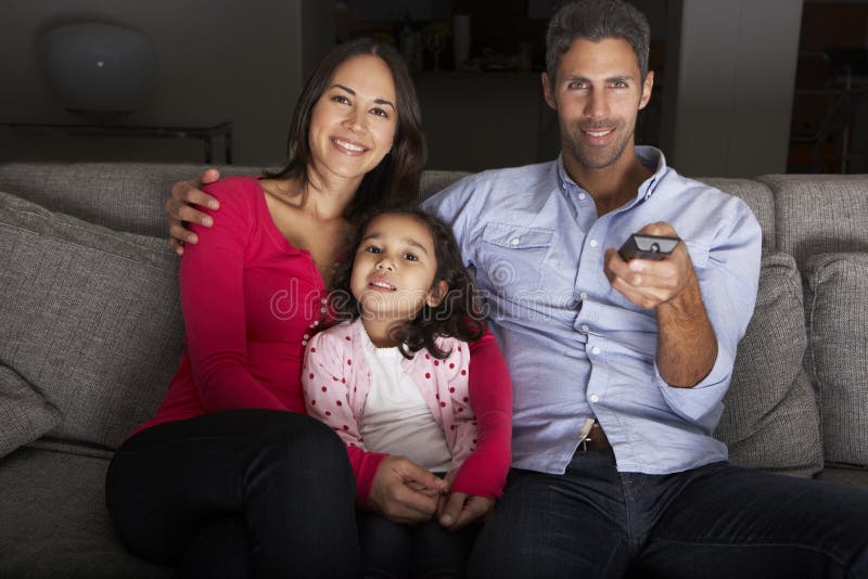 Hispanic Family Sitting On Sofa And Watching TV royalty free stock images Hispanic Family Sitting On Sofa And Watching TV royalty free stock images