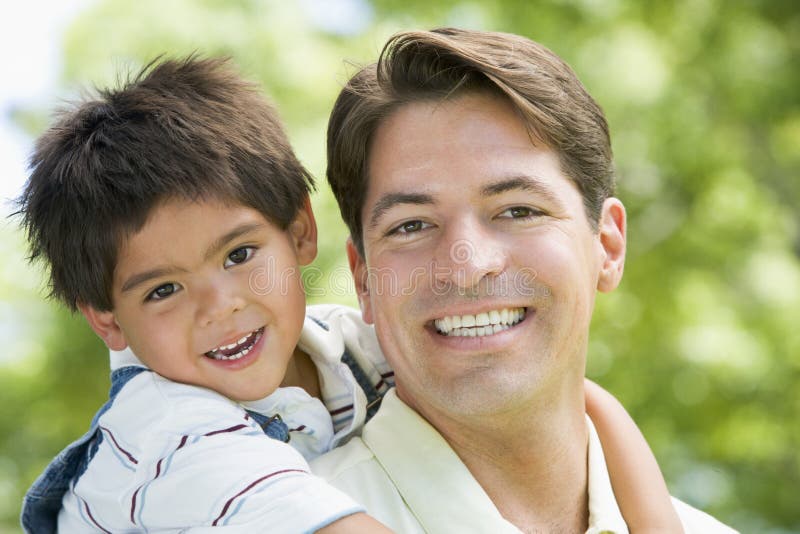 Hispanic father giving son piggy back stock photos Hispanic father giving son piggy back stock photos