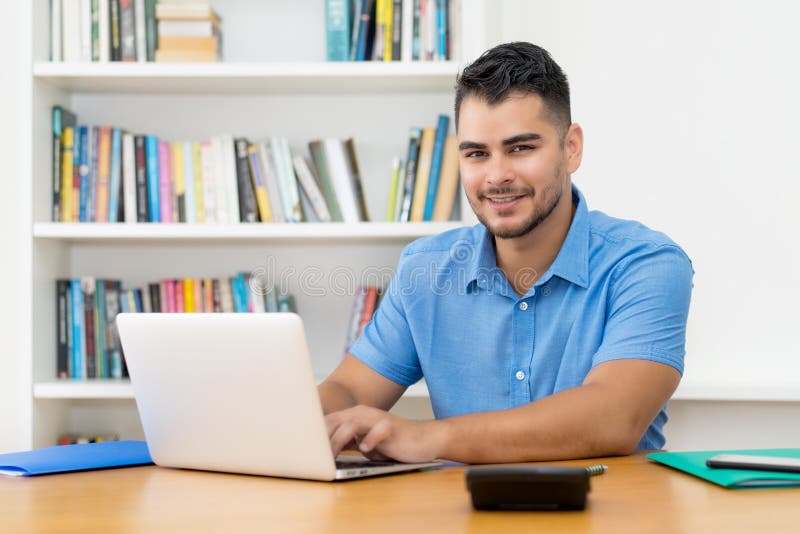 Hispanic hipster man with beard working at computer royalty free stock photography