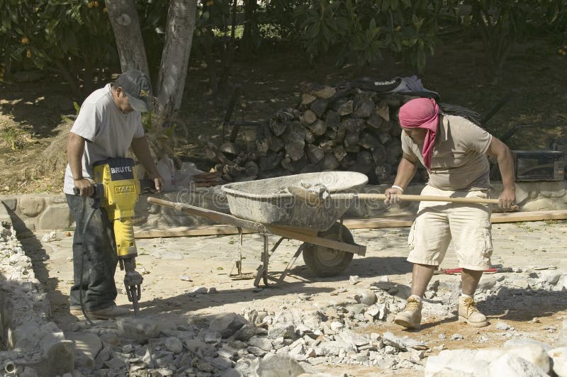 Hispanic males breaking concrete