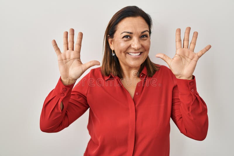 Hispanic Mature Woman Standing Over White Background Showing And Pointing Up With Fingers Number