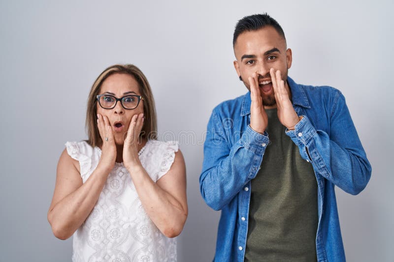 Hispanic Mother And Son Standing Together Afraid And Shocked Surprise 