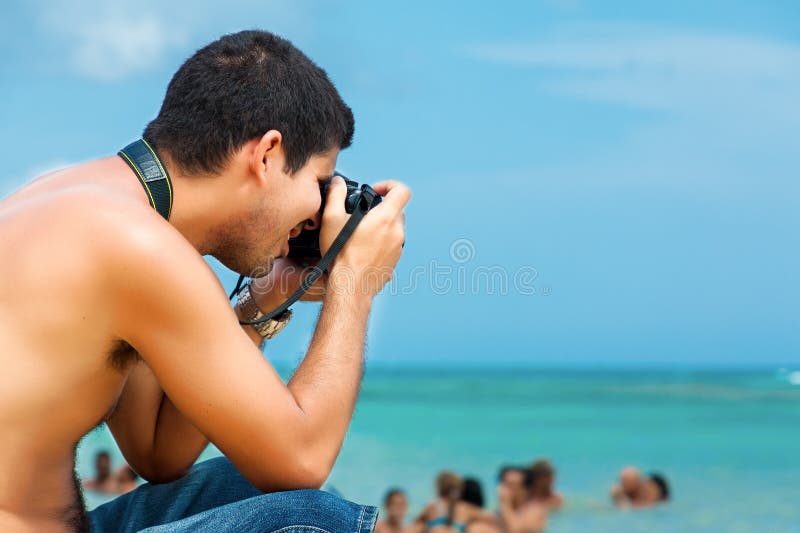 Hispanic photographer at the beach