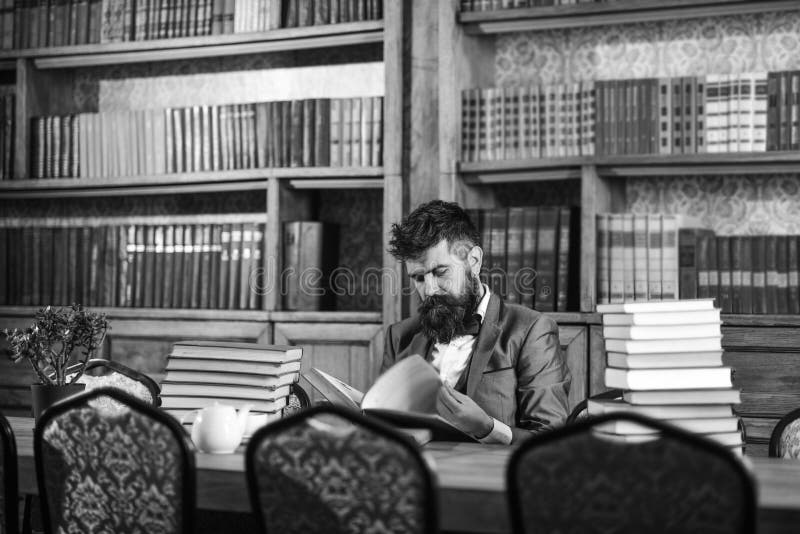 Historian Sits in Library and Reads Old Books. Stock Photo Image of