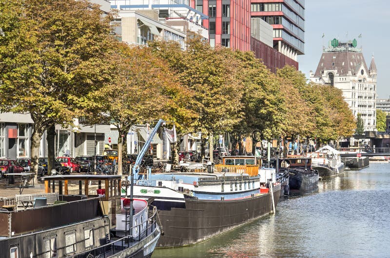 Rotterdam, The Netherlands, October 9, 2018: historic barges moored in the old Scheepmakershaven harbour basin, lined with chestnut trees in autumn colors. Barges rotterdam stock images, royalty-free photos and pictures
