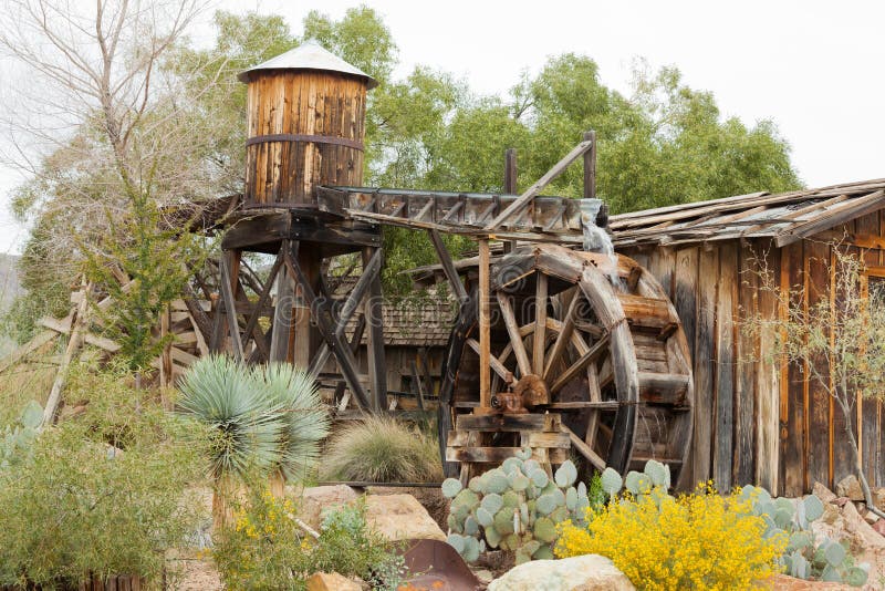 Historic wooden water mill building desert garden