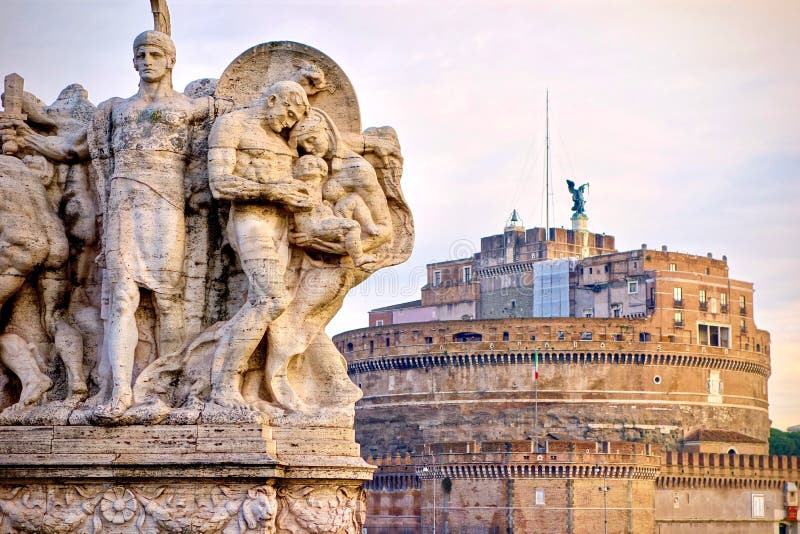 Historical monument from low angle with the statue in foreground and Engelsburg, Castel Sant�Angelo, Mausoleo di Adriano in the background. Rome, Italy. Historical monument from low angle with the statue in foreground and Engelsburg, Castel Sant�Angelo, Mausoleo di Adriano in the background. Rome, Italy