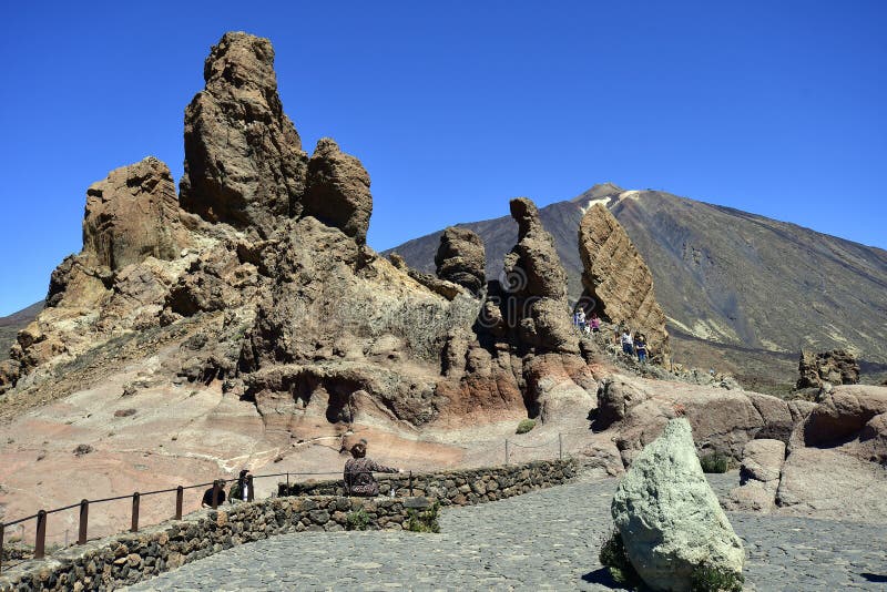 Tenerife, Canary Islands, Spain - April 05, 2018: Unidentified tourists at Los Roques rock formations with mount Teide behind. Tenerife, Canary Islands, Spain - April 05, 2018: Unidentified tourists at Los Roques rock formations with mount Teide behind