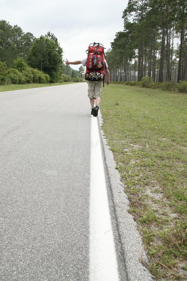 Lonely hitchhiker stock photo. Image of asphalt, baggage 27391604