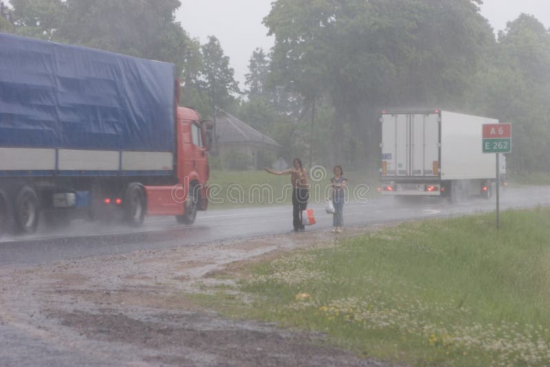 Hitchhikers in the rain stock image