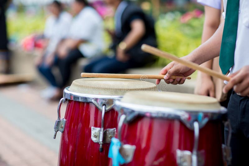 Hitting an African drums. Play on a musical instrument Drummer. Drum sticks hitting the drum. royalty free stock images