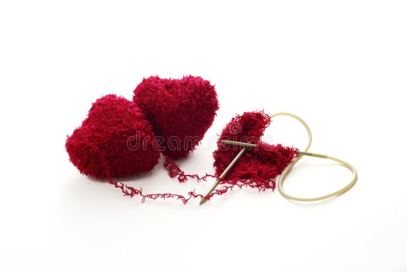 One heart knitted from two red heart shaped clews. One heart knitted from two red heart shaped clews