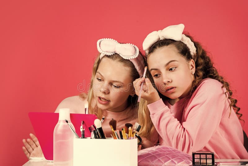 Hobby and fun. Cosmetics for children. Spa party. Sisterhood happiness. Skin care. Kids makeup. Beauty and fashion. Happy girls doing makeup. Beauty salon. Play with cosmetics. Cosmetics shop.