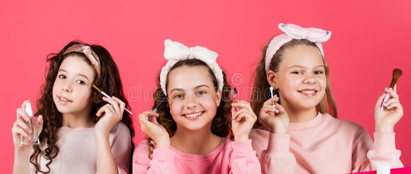 Hobby and fun. Happy girls doing makeup. Cute sisters play with cosmetics. Kids makeup. Cosmetics for children. Beauty