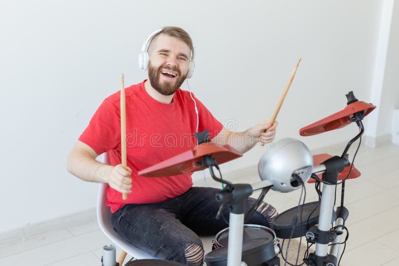 Hobby, music and people concept - Drummer man over the light background stock photos Hobby, music and people concept - Drummer man over the light background stock photos