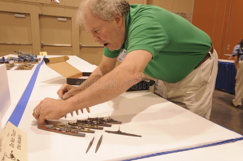 Man next to his display of nautical vessel models at the Modeling Convention in Phoenix, Arizona. Hobbyist and craftsman is a Participant at International stock images Man next to his display of nautical vessel models at the Modeling Convention in Phoenix, Arizona. Hobbyist and craftsman is a Participant at International stock images