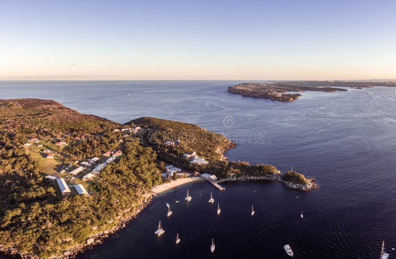 High angle aerial drone evening view of historical North Head Quarantine Station and Beach, located in Manly, Northern Beaches and part of Sydney Harbour National Park. South Head in the background. High angle aerial drone evening view of historical North Head Quarantine Station and Beach, located in Manly, Northern Beaches and part of Sydney Harbour National Park. South Head in the background.