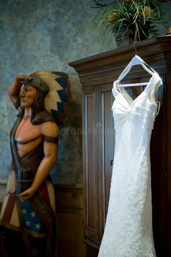 Hochzeitskleid, das nahe einem Zigarreinder hängt stockfotos Hochzeitskleid, das nahe einem Zigarreinder hängt stockfotos