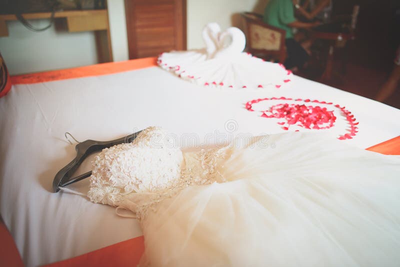 Wedding dress in room with rose petals, wedding decoration, Rose of Bouquet. Wedding dress in room with rose petals, wedding decoration, Rose of Bouquet