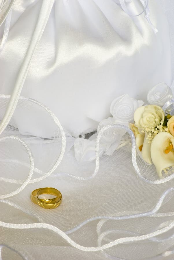 Bridal bag and wedding rings flowers decorations over bridal veil. Bridal bag and wedding rings flowers decorations over bridal veil