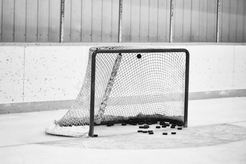 Hockey net full of pucks stock photos Hockey net full of pucks stock photos