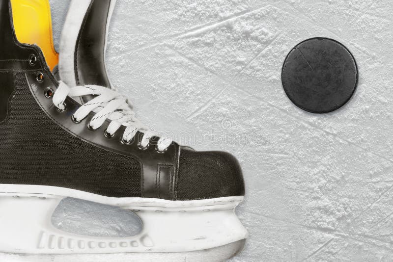 Hockey skates and puck stock photo. Image of round, object 36680556