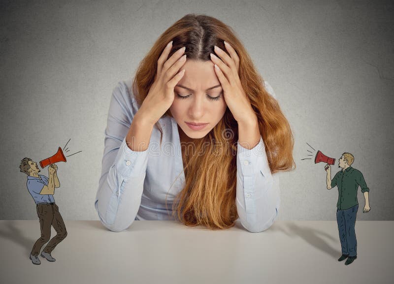 Desperate unhappy young business woman leaning on a desk two man with megaphone screaming at her isolated grey wall office background. negative human emotions face expression feelings life perception. Desperate unhappy young business woman leaning on a desk two man with megaphone screaming at her isolated grey wall office background. negative human emotions face expression feelings life perception
