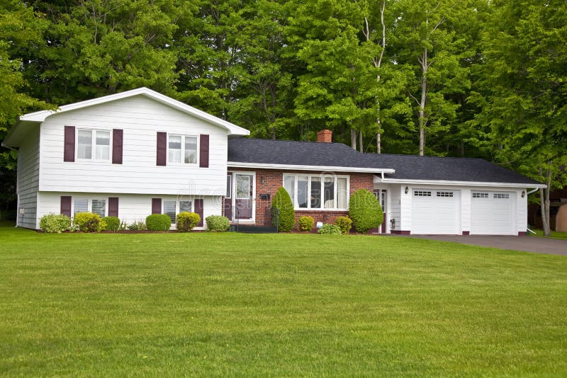 North America seventies era wooden split level home in suburbia. North America seventies era wooden split level home in suburbia.