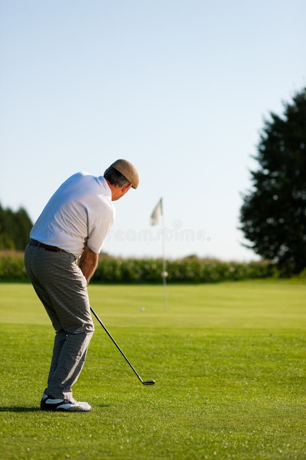 Senior golfer doing a golf stroke, he is playing on a wonderful summer afternoon. Senior golfer doing a golf stroke, he is playing on a wonderful summer afternoon